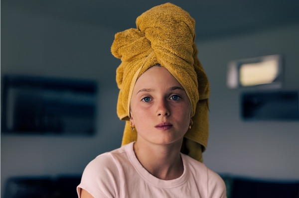 Portrait of a 12-year old girl with a towel twisted on her head